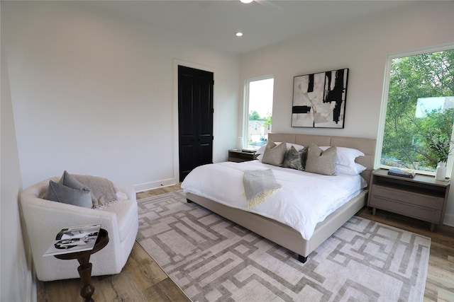 609 E 38th St, Houston, TX 77022 - bedroom with light wood-type flooring, multiple windows, and recessed lighting