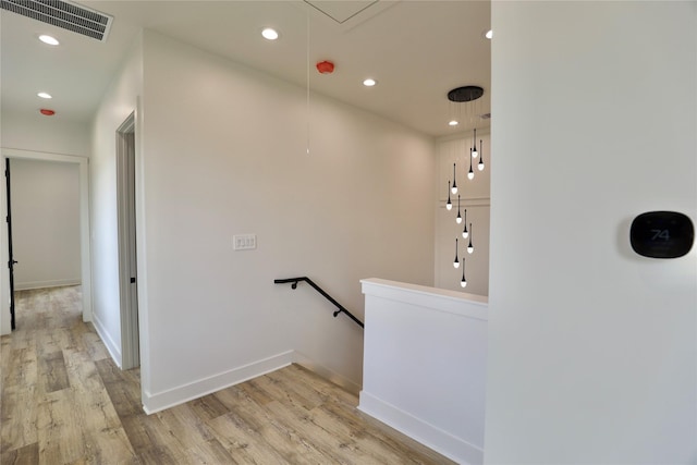 609 E 38th St, Houston, TX 77022 - corridor with attic access, an upstairs landing, light wood finished floors, recessed lighting, and baseboards