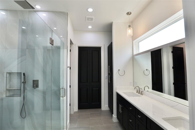 609 E 38th St, Houston, TX 77022 - full bathroom featuring a shower stall, tile patterned floors, double vanity, recessed lighting, and baseboards
