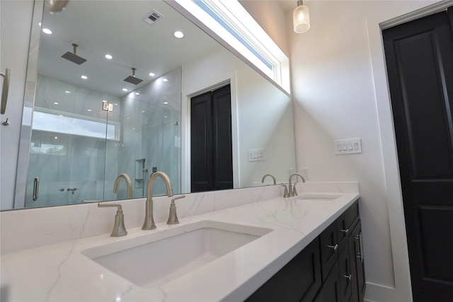 609 E 38th St, Houston, TX 77022 - bathroom featuring a marble finish shower and double vanity