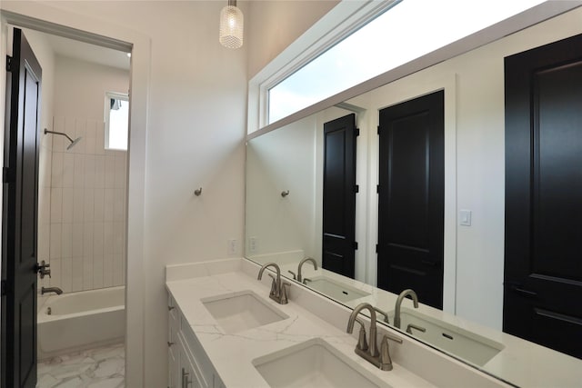 609 E 38th St, Houston, TX 77022 - full bathroom featuring shower / bathtub combination, double vanity, and marble look tiles