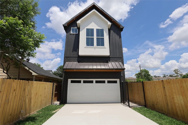 609 E 38th St, Houston, TX 77022 - view of front of property with a standing seam roof, driveway, fence, metal roof, and an attached garage