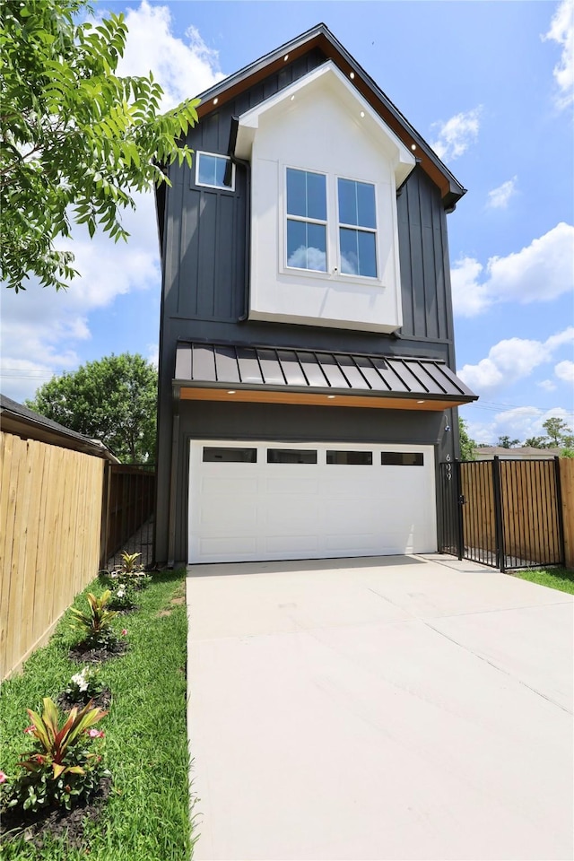 609 E 38th St, Houston, TX 77022 - modern home with a standing seam roof, board and batten siding, a garage, concrete driveway, and a metal roof