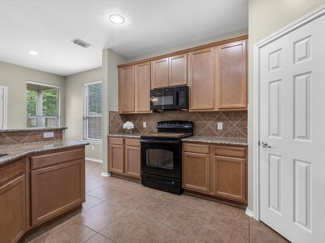 17510 Durham Ridge Ln, Humble, TX 77346 - kitchen with black appliances, decorative backsplash, light tile patterned floors, recessed lighting, and light stone countertops