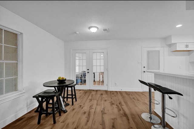 20310 County Road 510f, Brazoria, TX 77422 - dining room featuring french doors, baseboards, and light wood-style floors