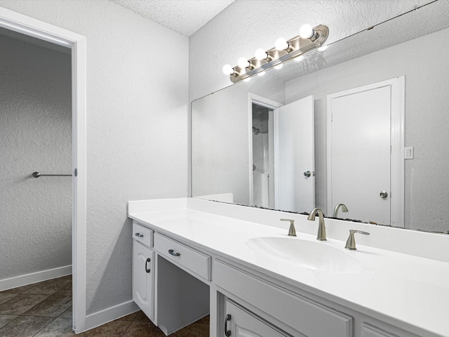 3808 Williams Rd, Benbrook, TX 76116 - full bathroom with a textured wall, vanity, a textured ceiling, baseboards, and a shower