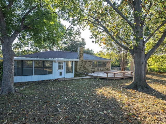 3808 Williams Rd, Benbrook, TX 76116 - rear view of property with a sunroom, a chimney, a wooden deck, and stone siding