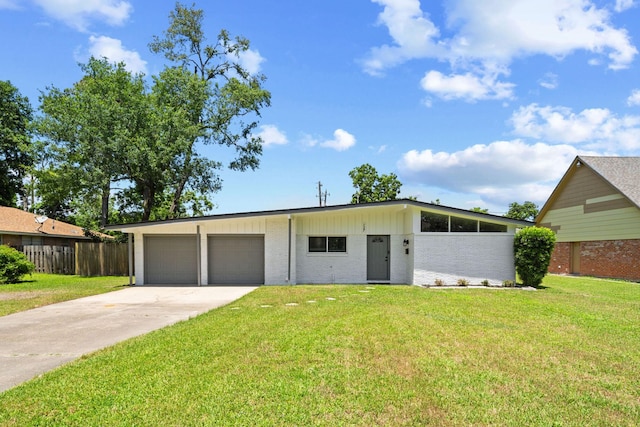 127 E Thornton Rd, Houston, TX 77022 - mid-century inspired home featuring an attached garage, driveway, and brick siding