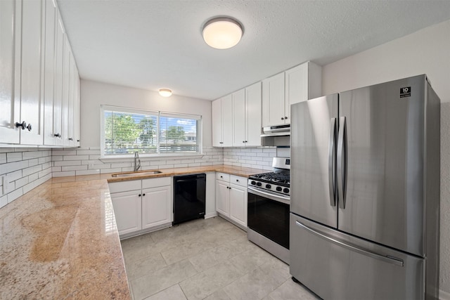 127 E Thornton Rd, Houston, TX 77022 - kitchen with stainless steel appliances, a sink, under cabinet range hood, light countertops, and white cabinets