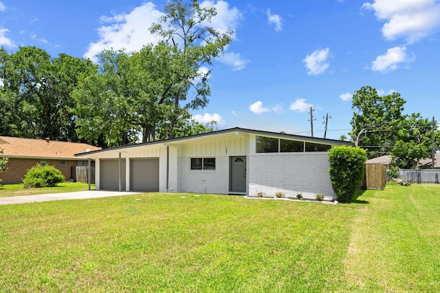 127 E Thornton Rd, Houston, TX 77022 - mid-century home featuring a garage, driveway, and brick siding
