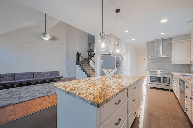 5918 Pendelton Place Dr, Sugar Land, TX 77479 - kitchen featuring appliances with stainless steel finishes, wall chimney exhaust hood, a center island, backsplash, and ceiling fan