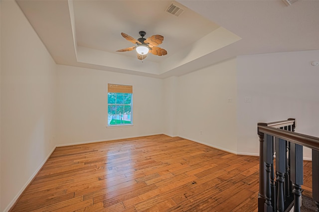 5918 Pendelton Place Dr, Sugar Land, TX 77479 - empty room with ceiling fan, a raised ceiling, hardwood / wood-style floors, and baseboards