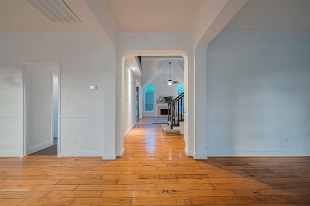5918 Pendelton Place Dr, Sugar Land, TX 77479 - hallway with arched walkways, light wood-style flooring, stairs, baseboards, and crown molding