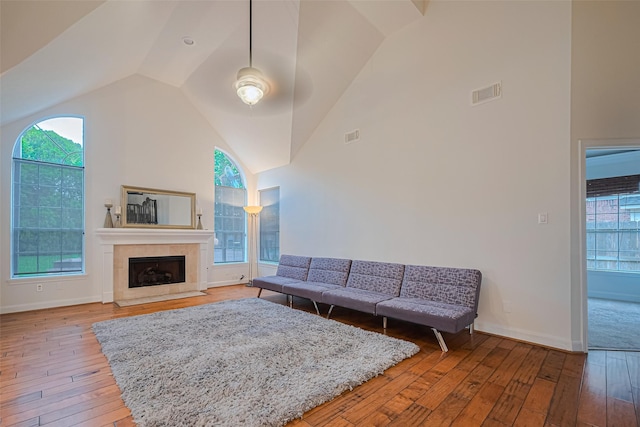 5918 Pendelton Place Dr, Sugar Land, TX 77479 - living area featuring light wood-style flooring, high vaulted ceiling, a fireplace with flush hearth, and healthy amount of natural light