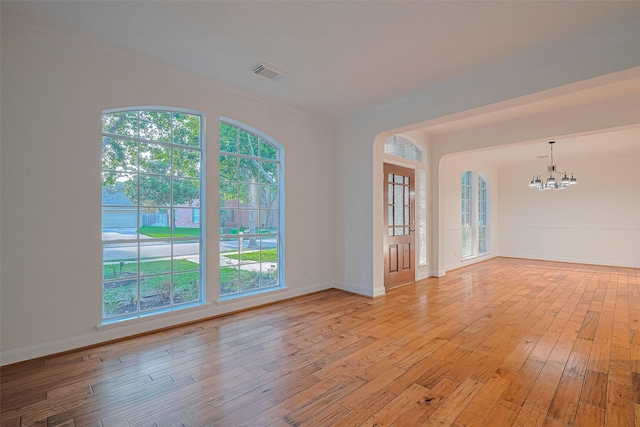 5918 Pendelton Place Dr, Sugar Land, TX 77479 - empty room with a chandelier, crown molding, light wood-type flooring, healthy amount of natural light, and baseboards