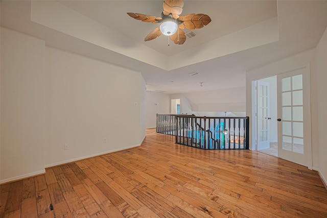 5918 Pendelton Place Dr, Sugar Land, TX 77479 - spare room with a raised ceiling, hardwood / wood-style flooring, a ceiling fan, and baseboards
