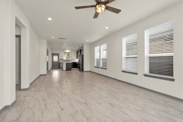 15206 Falco Ln, Magnolia, TX 77354 - unfurnished living room featuring ceiling fan, recessed lighting, and baseboards
