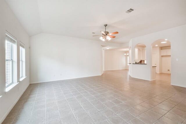 13507 Marblepointe Ln, Cypress, TX 77429 - unfurnished living room with ceiling fan, light tile patterned floors, baseboards, arched walkways, and lofted ceiling