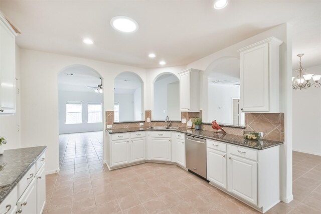 13507 Marblepointe Ln, Cypress, TX 77429 - kitchen with stainless steel dishwasher, a sink, arched walkways, decorative backsplash, and ceiling fan
