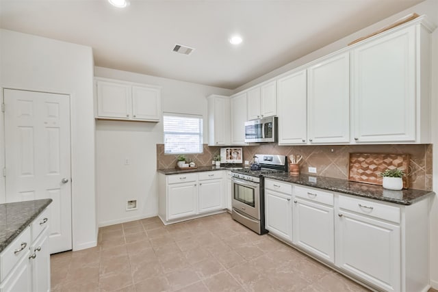 13507 Marblepointe Ln, Cypress, TX 77429 - kitchen with appliances with stainless steel finishes, white cabinets, tasteful backsplash, dark stone counters, and recessed lighting
