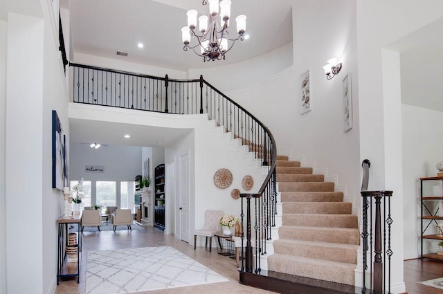 11307 Bentgrove Ln, Cypress, TX 77433 - staircase featuring a high ceiling, a chandelier, baseboards, recessed lighting, and wood finished floors