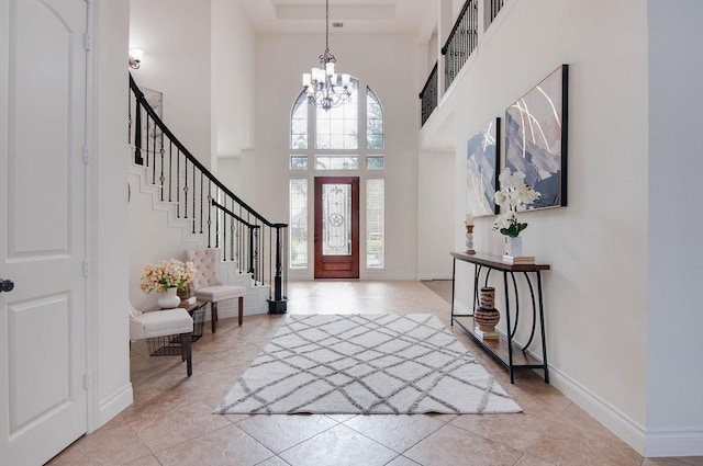 11307 Bentgrove Ln, Cypress, TX 77433 - entryway with a high ceiling, a chandelier, stairs, baseboards, and light tile patterned floors
