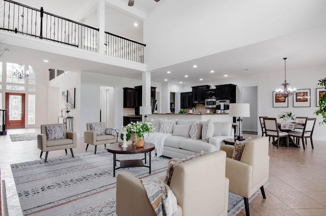 11307 Bentgrove Ln, Cypress, TX 77433 - living area with a chandelier, a high ceiling, light tile patterned flooring, recessed lighting, and baseboards