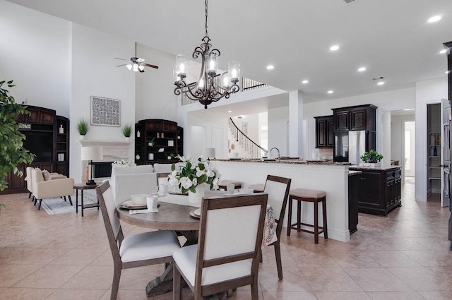 11307 Bentgrove Ln, Cypress, TX 77433 - dining area featuring a ceiling fan, light tile patterned floors, recessed lighting, stairs, and a chandelier