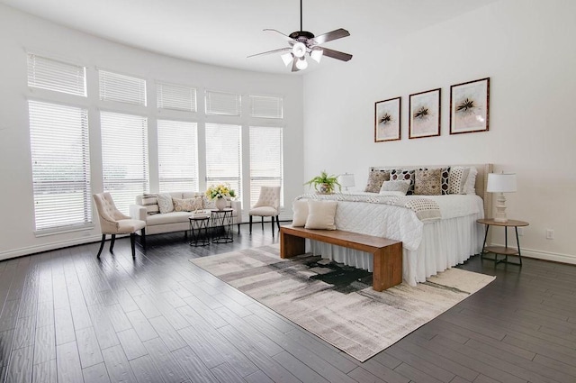 11307 Bentgrove Ln, Cypress, TX 77433 - bedroom with multiple windows, dark wood-type flooring, baseboards, a towering ceiling, and a ceiling fan