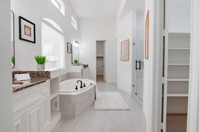 11307 Bentgrove Ln, Cypress, TX 77433 - bathroom with a spacious closet, a stall shower, vanity, and a garden tub