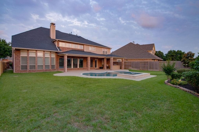 11307 Bentgrove Ln, Cypress, TX 77433 - rear view of property featuring brick siding, a chimney, and a patio area