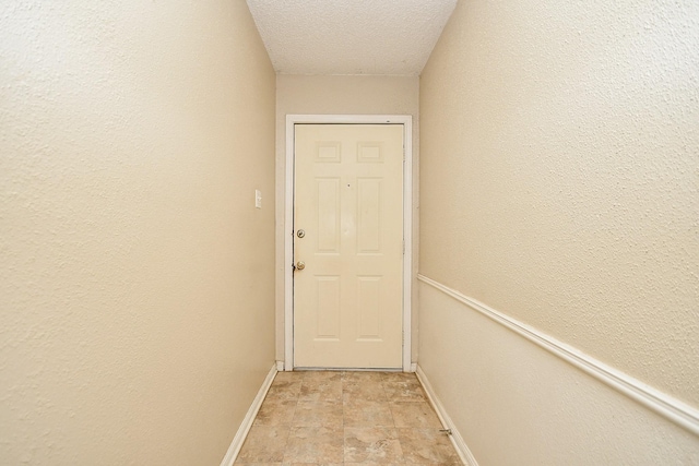 12618 Foxburo Dr, Houston, TX 77065 - doorway with baseboards and a textured ceiling