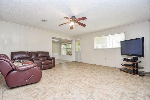 12618 Foxburo Dr, Houston, TX 77065 - living room featuring ceiling fan, a textured ceiling, and ornamental molding