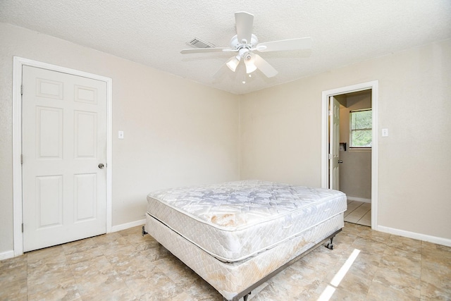 12618 Foxburo Dr, Houston, TX 77065 - bedroom featuring a textured ceiling, baseboards, and ceiling fan