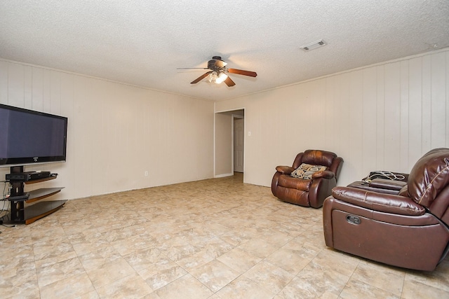 12618 Foxburo Dr, Houston, TX 77065 - sitting room with ceiling fan, a textured ceiling, and wood walls
