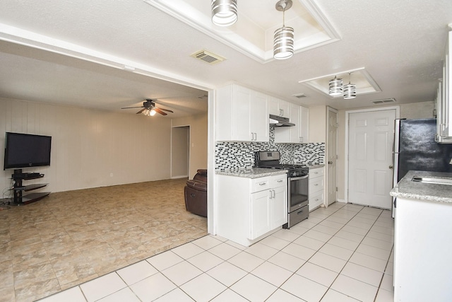 12618 Foxburo Dr, Houston, TX 77065 - kitchen featuring stainless steel appliances, open floor plan, under cabinet range hood, and white cabinets