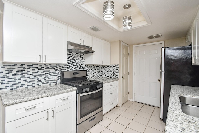 12618 Foxburo Dr, Houston, TX 77065 - kitchen featuring appliances with stainless steel finishes, under cabinet range hood, white cabinetry, light tile patterned floors, and backsplash