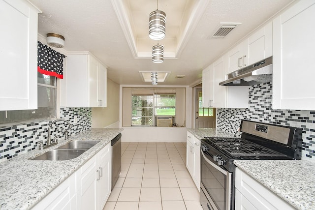 12618 Foxburo Dr, Houston, TX 77065 - kitchen featuring stainless steel appliances, under cabinet range hood, a sink, light tile patterned floors, and white cabinets