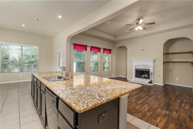 1938 Honey Laurel Dr, Conroe, TX 77304 - kitchen featuring a sink, dishwasher, ceiling fan, open floor plan, and baseboards
