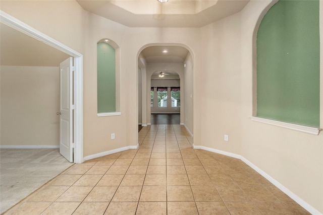 1938 Honey Laurel Dr, Conroe, TX 77304 - hallway with arched walkways, light tile patterned floors, and baseboards