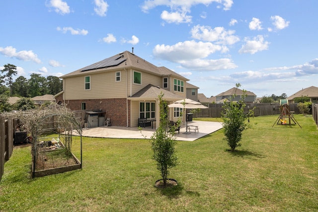 9001 Cimarron River Ln, Magnolia, TX 77354 - back of property with a patio area, solar panels, a garden, and brick siding