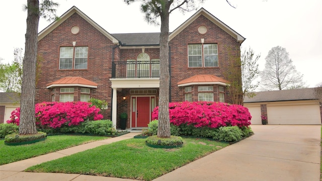 7907 Gulf Isle Ct NE, Houston, TX 77095 - view of front facade with a balcony, brick siding, a front lawn, and a garage