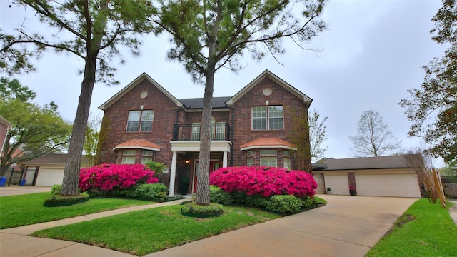 7907 Gulf Isle Ct NE, Houston, TX 77095 - view of front of home featuring a balcony, brick siding, a front lawn, a garage, and a standing seam roof