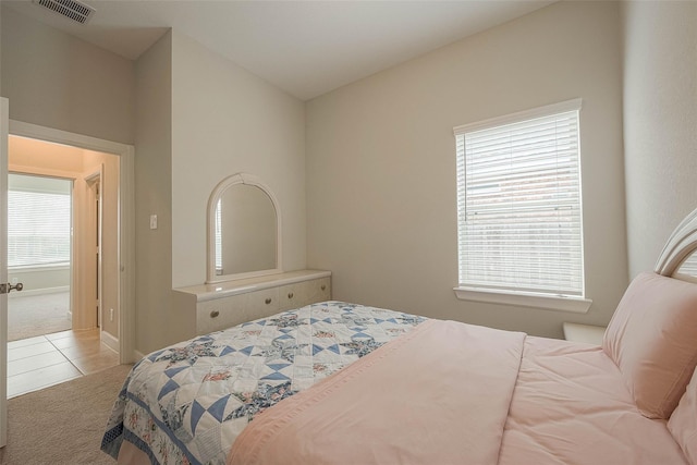 8107 Silverspot Ln, Missouri City, TX 77459 - carpeted bedroom with tile patterned floors and baseboards