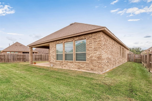 8107 Silverspot Ln, Missouri City, TX 77459 - view of side of home with brick siding, a patio area, and roof with shingles