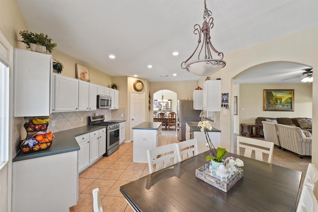 18206 Noble Forest Dr, Humble, TX 77346 - dining space featuring arched walkways, light tile patterned floors, recessed lighting, and ceiling fan