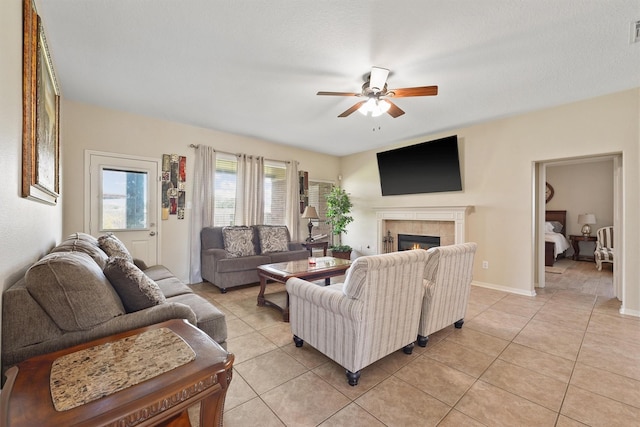 18206 Noble Forest Dr, Humble, TX 77346 - living room with a ceiling fan, light tile patterned flooring, and a tile fireplace