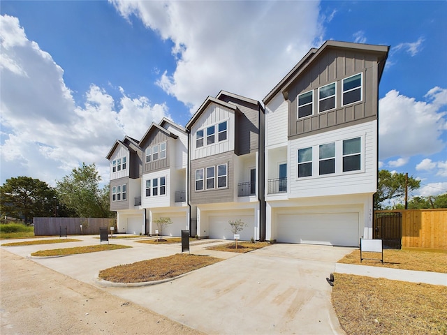 6834 Lozier St, Houston, TX 77021 - view of front of home featuring board and batten siding, an attached garage, concrete driveway, and fence
