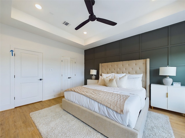 6834 Lozier St, Houston, TX 77021 - bedroom featuring a tray ceiling, light wood finished floors, recessed lighting, and ceiling fan