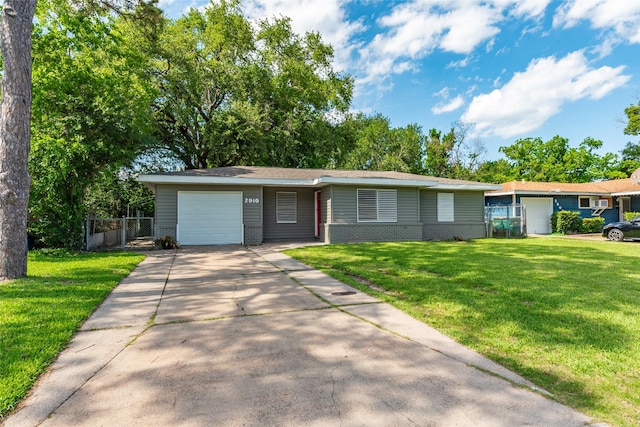 2910 John St, La Marque, TX 77568 - ranch-style home with a garage, driveway, brick siding, and a gate